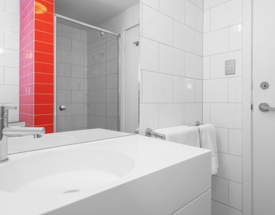 Sink in white and red bathroom