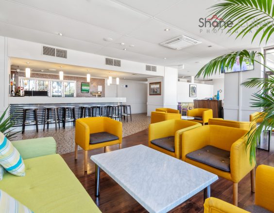 Bright yellow chairs and marble table at Plaza Hotel